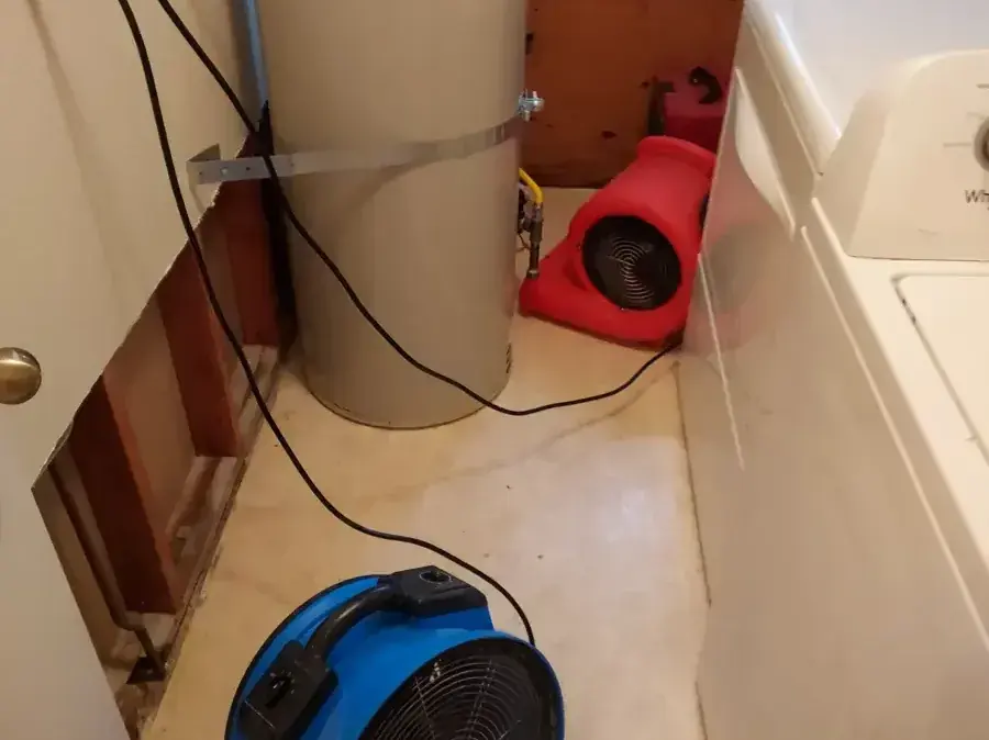 The wall behind a washer opened with air movers aimed at the cavity