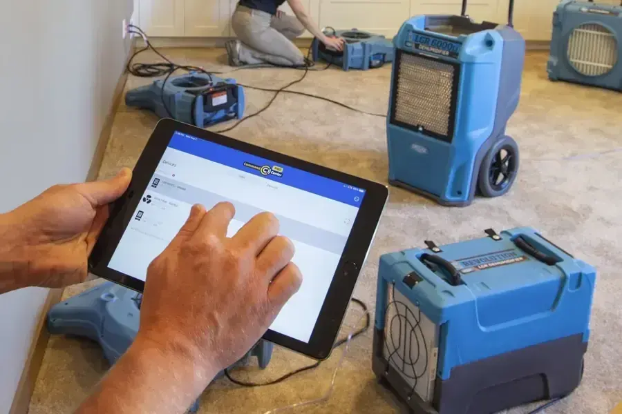 Portable pump and drying equipment set up in a vented crawl space after a leak
