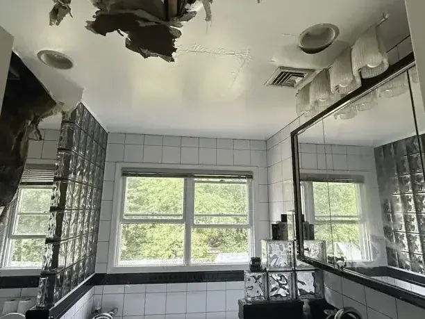 Collapsed bathroom ceiling after a leak from the floor above